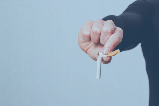 Joint Replacement Smoking Effects on Healing Person breaking a cigarette to quit smoking