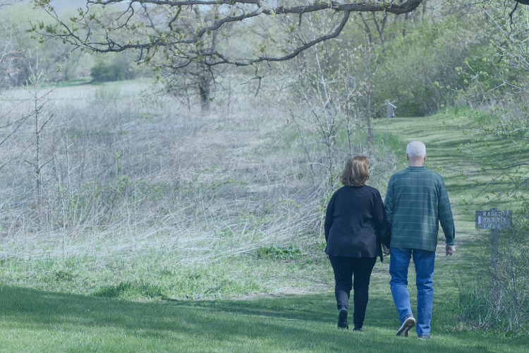 Older couple walking in fields