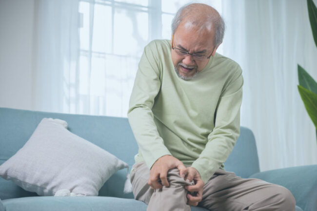 Man holding knee in pain