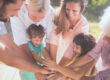 Different generations outside with hands in a pile