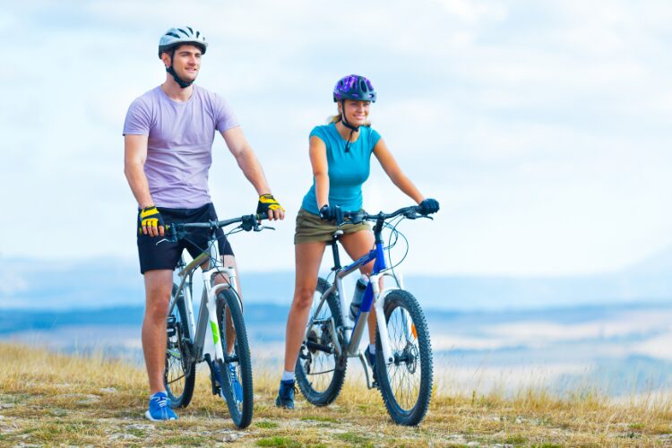 Couple out cycling looking healthy and happy