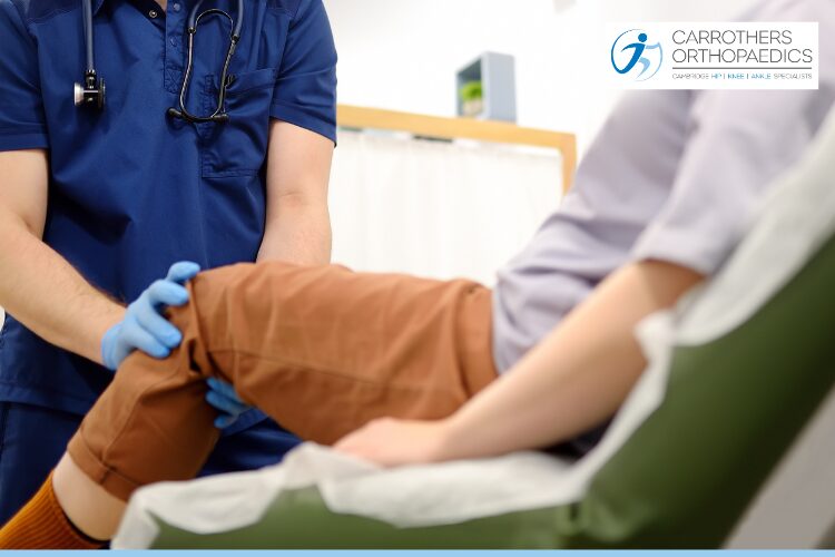Orthopaedic surgeon assessing a woman's knee