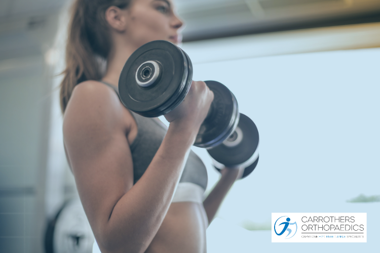 Woman in gym lifting weights