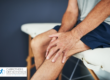 Man on doctor's bench holding knee
