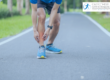 Sports man running holding shin in pain