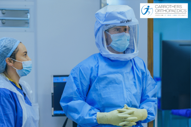 Mako Joint Replacement Surgery Patient Reviews Andrew Carrothers preparing for Mako robotic assisted joint replacement surgery wearing Stryker surgical clothing
