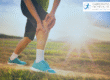 Runner holding the front of his knee whilst out running in the country