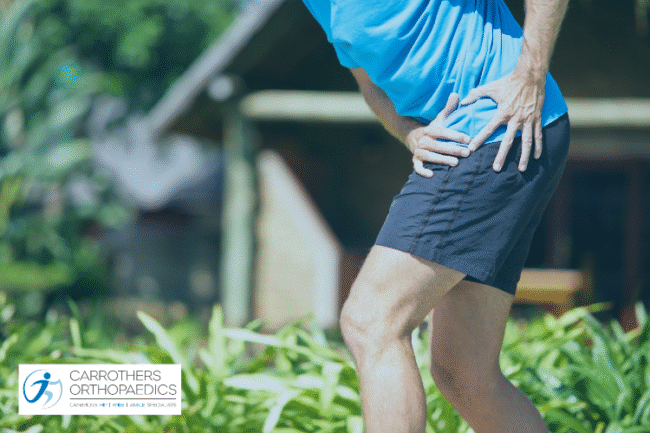 Man holding his hip in pain