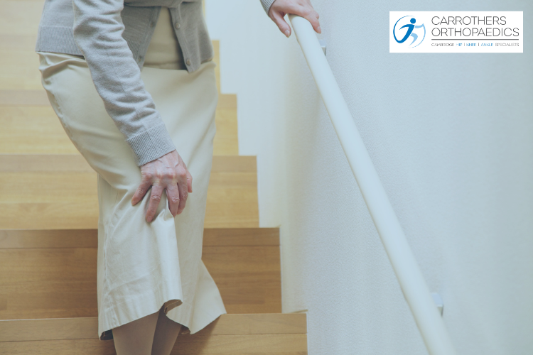 What You Need to Know About Joint Replacement Surgery Older woman holding knee coming down stairs