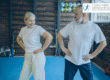 Happy middle age man and women in a fitness studio doing gentle exercise