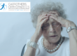 Older woman holding head looking very tired