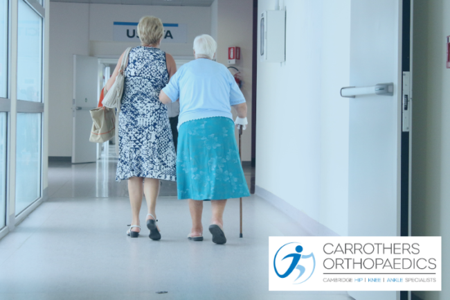 Total and Partial Hip Replacements Differences Older woman leaving hospital with a walking stick and family member