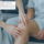 Man sitting down with medical professional assessing his knee