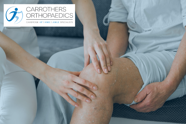 Man sitting down with medical professional assessing his knee