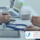 Patient consultant consultation, talking over desk with stethoscope, laptop and tablet