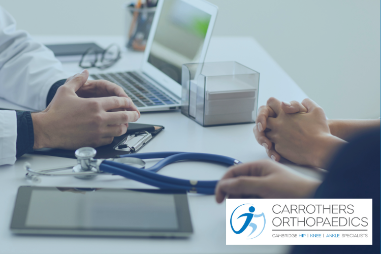 Patient consultant consultation, talking over desk with stethoscope, laptop and tablet